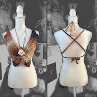 a mannequin with a crocheted top and necklace