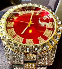a red watch with diamonds on it