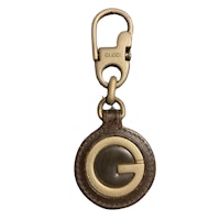 a brown leather key ring with the letter g on it