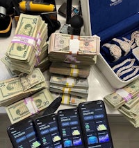 a pile of cash and cell phones on a counter