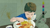 a boy eating spaghetti with a fork