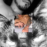 a black and white photo of a man with tattoos and a cat