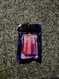 a package of lipsticks sitting on the grass