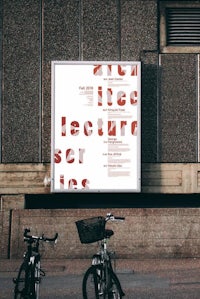 a bicycle is parked in front of a building with a poster