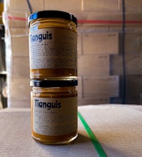two jars of tanguus on top of a box