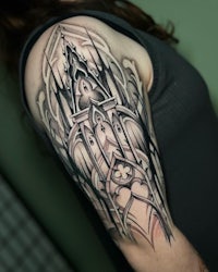 a woman with a tattoo of a castle on her sleeve