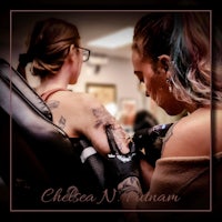two women getting tattoos at a tattoo shop