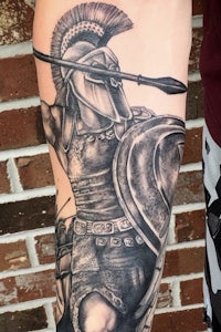 a tattoo of a spartan with a spear and shield