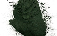 a pile of green powder on a white background