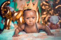 a baby wearing a crown on his head