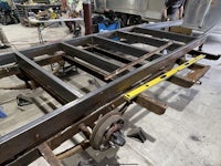 the frame of a boat is being made in a workshop