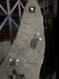 a rock with inscriptions on it is displayed in a building