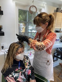 a woman is getting her hair done in a salon