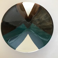 a plate with a black, brown, and white design