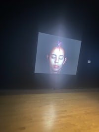 a projection of a woman's face in a dark room