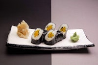japanese sushi on a black and white plate