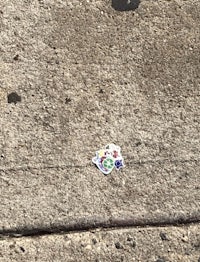 a piece of paper on the sidewalk