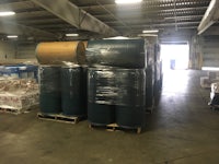 a large warehouse filled with barrels and pallets