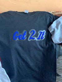 a black t - shirt with the word get 2 it on it