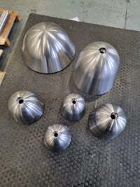 a group of stainless steel cones on a table