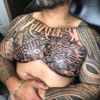 a man with tattoos on his chest