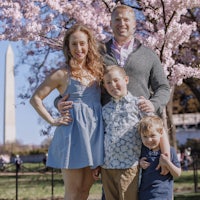a family posing in front of the washington monument