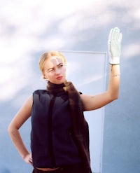 a woman wearing gloves and a scarf