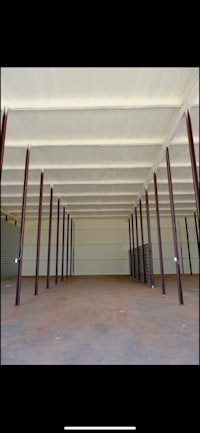 the inside of a large warehouse with columns and beams