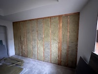 a room that is being insulated with wood panels