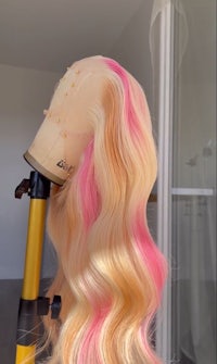 a wig with pink and yellow wavy hair