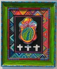 a colorful framed painting of a cross and a flower