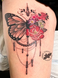 a butterfly tattoo on a woman's thigh