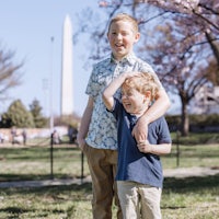 two boys standing in front of the washington monument