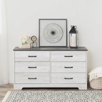 a white dresser with drawers and a rug