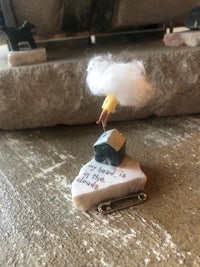 a miniature house with a cloud on top of it
