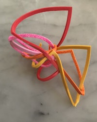 a piece of jewelry made out of different colored plastics