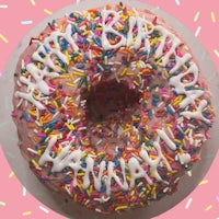 a donut with sprinkles and a happy birthday message