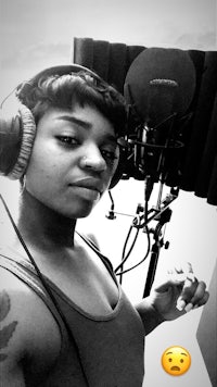 a woman wearing headphones in a recording studio