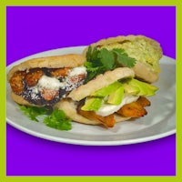 three sandwiches on a plate on a purple background