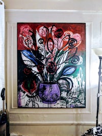 a painting of flowers in a vase in a room