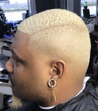 a man with blond hair in a barber shop