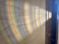 a rainbow is seen through a window in a room