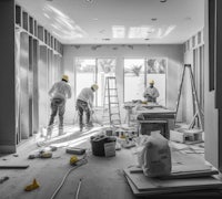 black and white photo of construction workers in a room
