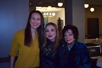 three women posing for a picture in a restaurant