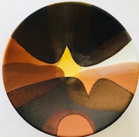a plate with a black, brown and orange design