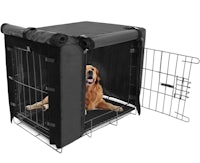 a black dog crate with a golden retriever inside