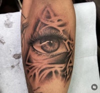 a tattoo of an eye with a triangle on it