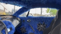 the interior of a car is covered in blue fur