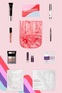a pink bag with cosmetics and other items on it