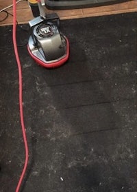 a vacuum cleaner is being used to clean a carpet